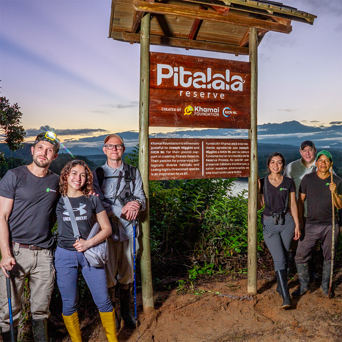 Image showing the BioBlitz team posing besides the wood sign at the Pitalala Reserve