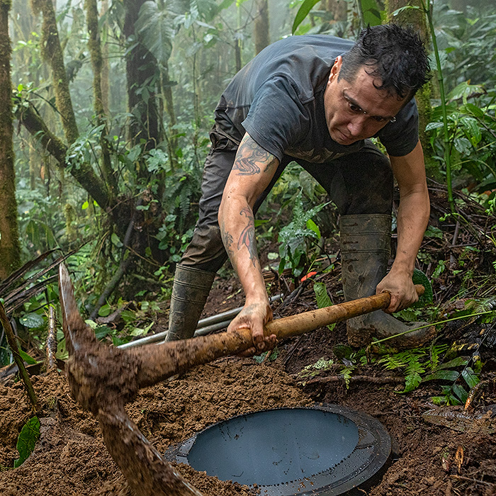 Image showing a biologist setting up a pitfall trap in the cloud forest