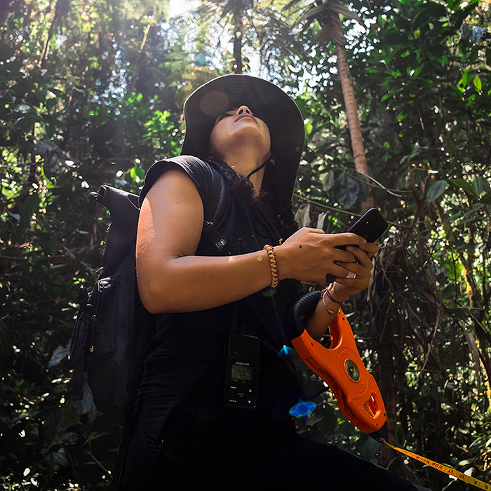 Image showing biologist Amanda Quezada record the coordinates at the start of a river transect at Arlequín Reserve