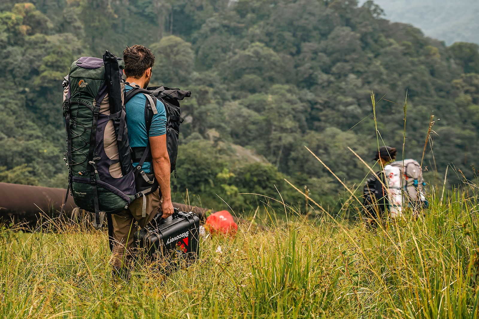 Image showing biologist Alejandro Arteaga carrying heavy equipment during an expedition