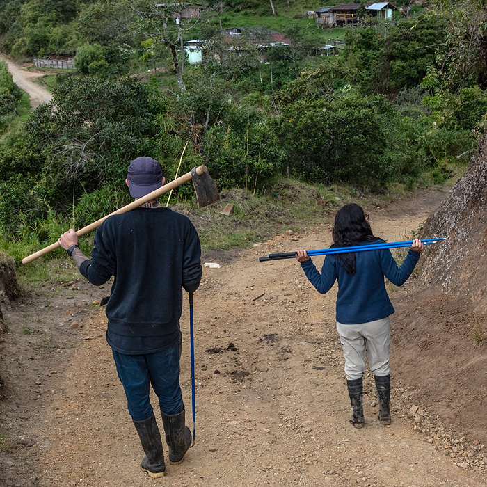 Image showing two biologists holding snake hooks